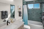 And a shared bathroom in the hallway with a modern bath/shower combo